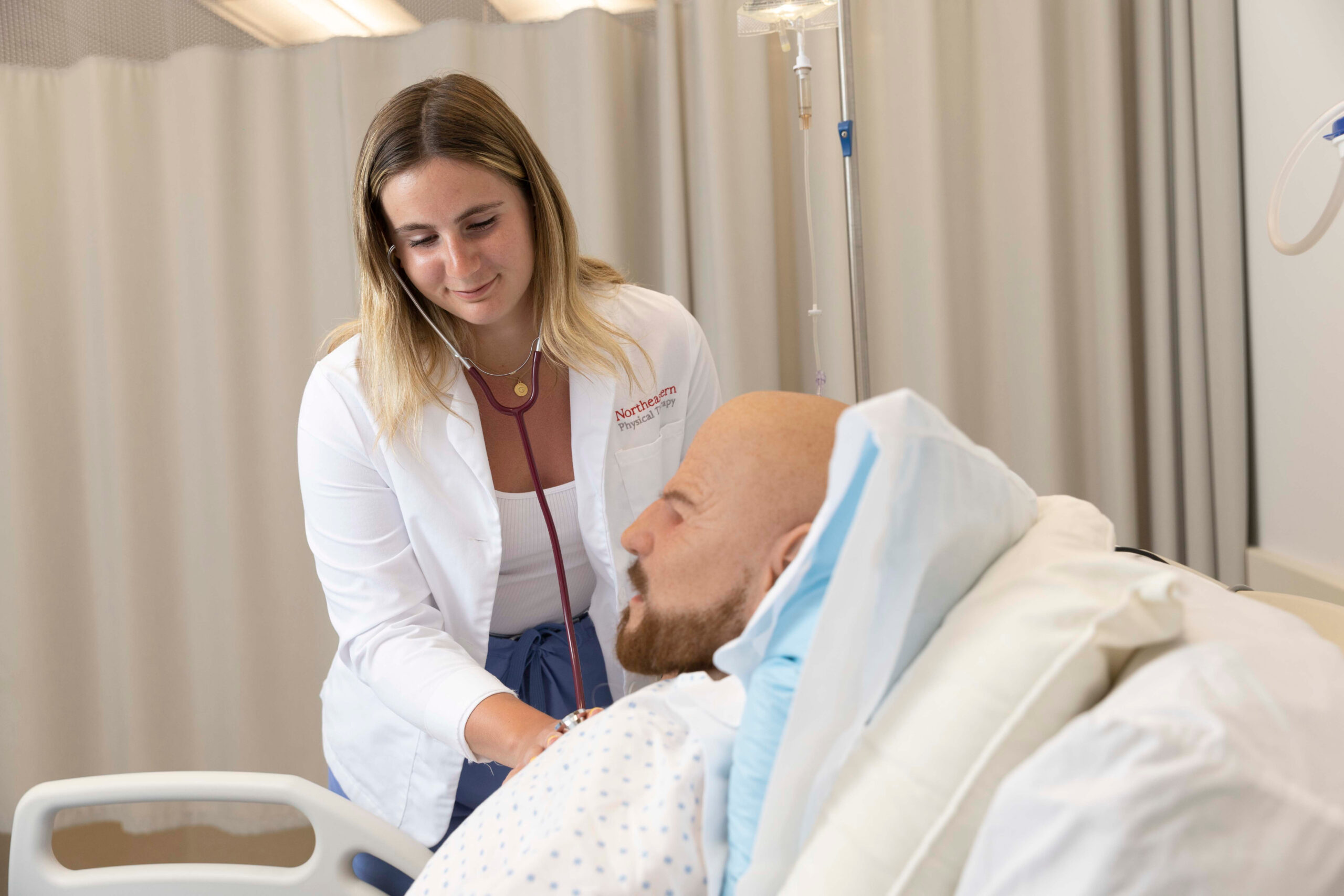 Health science student examines robot patient at the nursing practice lab at Northeastern University